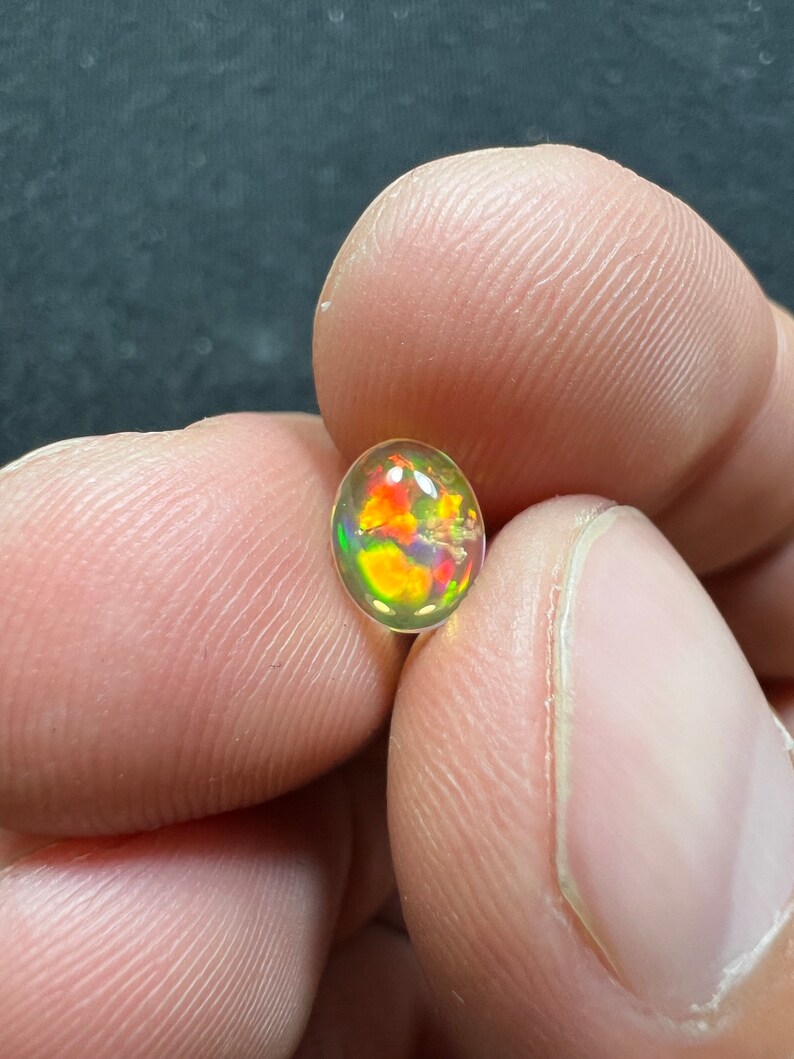 Amazing fire opal with its beautiful sparkles and quarry inlay AAA quality weight 0.65 carats measure 7.5x6x3mm image 2