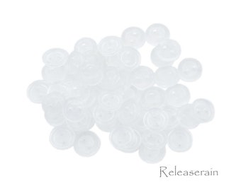 May include: A pile of white plastic buttons. The buttons are round and have two holes.