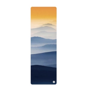 May include: A yoga mat with a blue and yellow mountain landscape design. The mountains are layered and fade into a misty background.