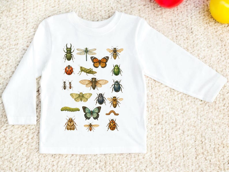 May include: White long-sleeved shirt featuring a colorful insect illustration. The design includes various bugs like beetles, butterflies, bees, and dragonflies. The shirt is made of a soft, comfortable material.