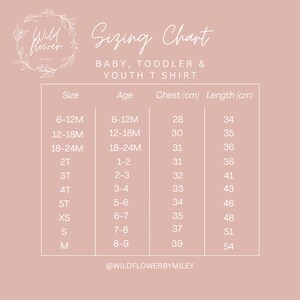 May include: A sizing chart for baby, toddler, and youth t-shirts. The chart lists sizes from 6-12 months to size M, with corresponding age ranges, chest measurements in centimeters, and length measurements in centimeters. The chart is on a light pink background with the text "Wildflower by Miley" at the bottom.