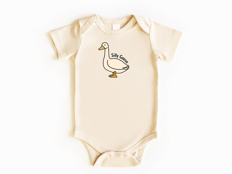 May include: A cream-colored baby onesie with a cartoon goose illustration and the text "Silly Goose" printed on the front.