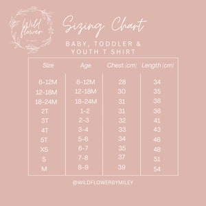 May include: A sizing chart for baby, toddler, and youth t-shirts. The chart lists sizes from 6-12 months to size M, with corresponding age ranges, chest measurements in centimeters, and length measurements in centimeters. The chart is on a light pink background with the text "Wildflower by Miley" at the bottom.