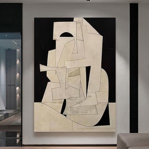 May include: Abstract art painting with geometric shapes in black and white. The shapes are layered and overlapping, creating a sense of depth and dimension. The painting is on a canvas and has a textured surface.