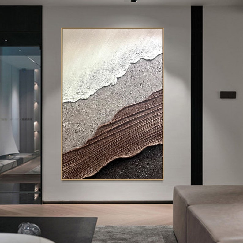 May include: Abstract painting with brown, white, and gray textured brushstrokes. The painting is framed in a thin gold frame.