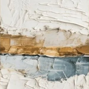 May include: Abstract textured art piece with a rectangular shape. The artwork features layers of white, gold, and blue-gray colors, applied with thick brushstrokes, creating a tactile, three-dimensional effect. The piece has a modern, minimalist aesthetic.
