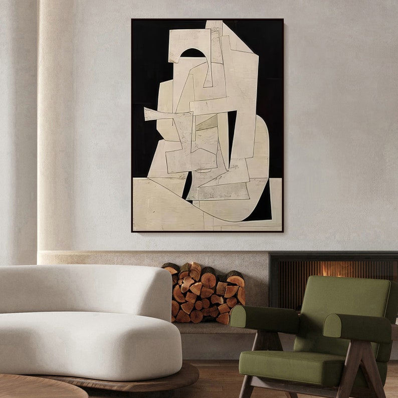 May include: Abstract art print with geometric shapes in white and black on a black background. The print is framed and hanging on a wall in a modern living room.