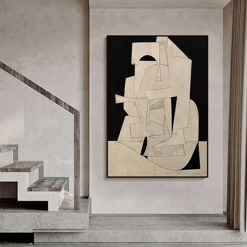 May include: Abstract art print with geometric shapes in white and black on a beige background. The print is framed in a black frame.
