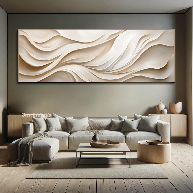 May include: A large abstract painting with flowing white and beige lines. The painting is hanging on a wall in a living room setting with a couch, coffee table, and rug.