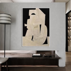 May include: Abstract art print with geometric shapes in white and black on a canvas. The shapes are layered and overlapping, creating a sense of depth and movement.