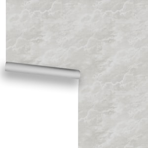 May include: A white wallpaper with a cloudy, textured pattern. The wallpaper is rolled up and partially unrolled, showing the pattern.