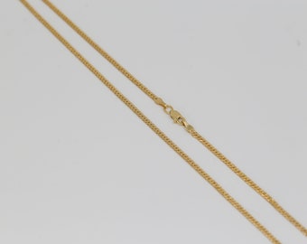 May include: A gold chain necklace with a lobster clasp closure.