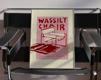 May include: A black leather and chrome Wassily chair with a pink and white poster on the seat that reads "Wassily Chair" with a line drawing of the chair. The poster also includes the text "Marcel Breuer 1925-1926" and "Design Museum"