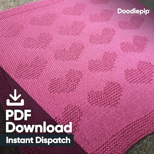 May include: A pink knitted blanket with a heart pattern. The blanket is made with a simple stitch and has a subtle texture. The text "PDF Download Instant Dispatch" is in the bottom left corner of the image.