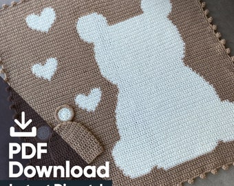 May include: A handmade crochet baby blanket in brown and white, featuring a bear silhouette and white hearts. The blanket has a scalloped edge and is accompanied by a matching hat and coaster. The text "Doodlepip" is visible in the top right corner.