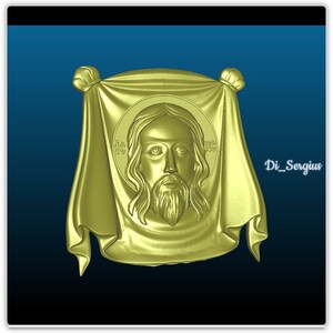 May include: A gold-colored, three-dimensional relief sculpture of Jesus Christ's face. The face is surrounded by a draped cloth with a knot at the top.