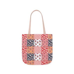 May include: A pink and red patchwork tote bag with a floral and heart pattern.