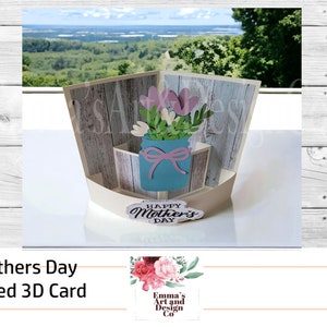 May include: A 3D pop-up card with a rustic woodgrain background. The card features a blue mason jar with pink and white flowers and a "Happy Mother's Day" message.