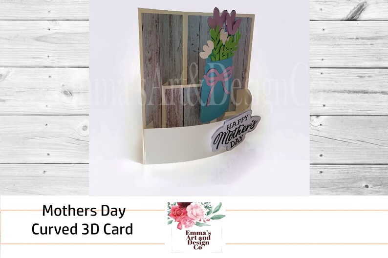 May include: A 3D pop-up card with a curved design. The card features a blue mason jar with pink and white flowers and a wooden background. The card says "Happy Mother's Day".