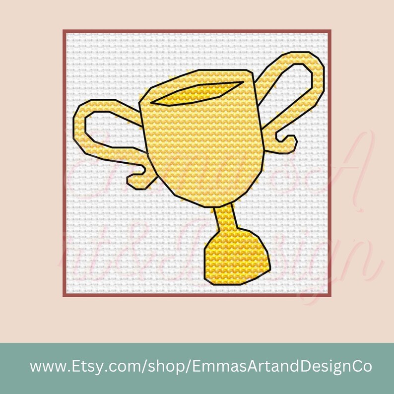 May include: A cross-stitch design of a gold trophy on a white background, framed in a red border. The trophy has a cup-shaped top with two handles and a pedestal base. The website address www.Etsy.com/shop/EmmasArtandDesignCo is at the bottom.
