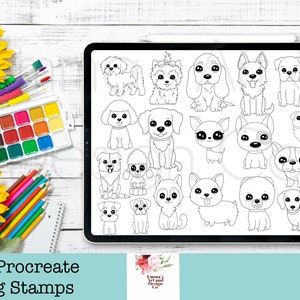 May include: A digital tablet screen showing 20 black and white illustrations of different dog breeds. The illustrations are simple and cartoonish, with large eyes and playful expressions. The tablet is surrounded by art supplies, including paintbrushes, coloured pencils, and a watercolour palette.