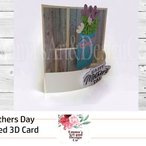 May include: A 3D pop-up card with a curved design. The card features a blue mason jar with pink and white flowers and a wooden background. The card says "Happy Mother's Day".