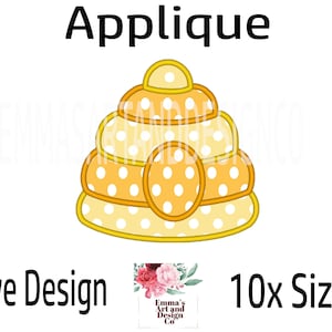 May include: Applique design of a yellow and white beehive with polka dots. The design is labelled "Hive Design" and "10x Sizes".