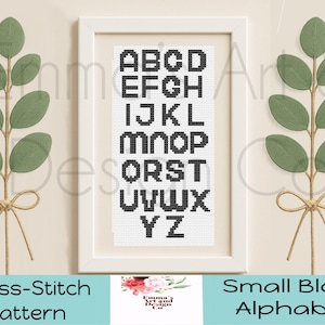 May include: A framed cross-stitch pattern featuring a small block alphabet in black on a white background. The frame is white, and the image is flanked by green leaf sprigs tied with twine bows. The text "Cross-Stitch Pattern" and "Small Block Alphabet" are at the bottom.