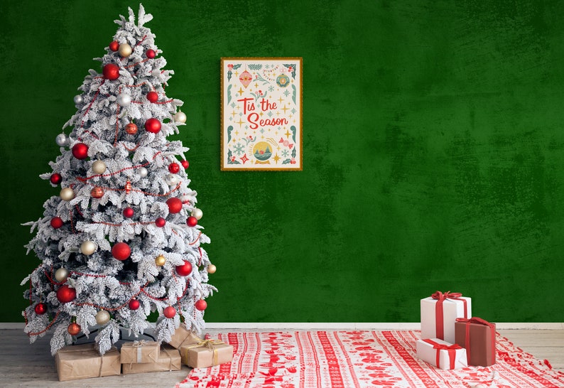 May include: A snowy Christmas tree decorated with red and gold ornaments, red and white garland, and presents underneath. A framed print with the text "Tis the Season" hangs on a green wall behind the tree. A red and white patterned rug is on the floor in front of the tree.
