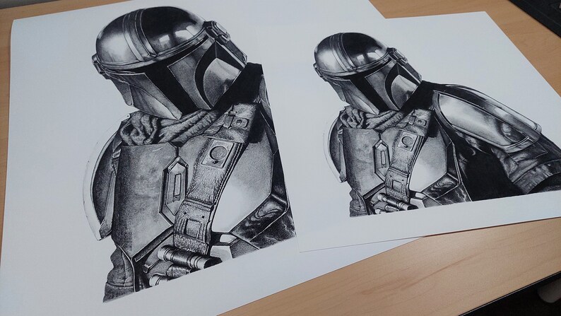 May include: A black and white pencil drawing of a Mandalorian character from the Star Wars franchise. The character is wearing a helmet and armor, and is holding a weapon.