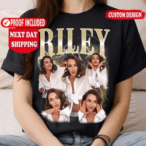 May include: Black t-shirt featuring a custom design with the name "RILEY" in gold lettering. The shirt displays a collage of images of a person wearing a white shirt. The shirt also has the text "PROOF INCLUDED" and "NEXT DAY SHIPPING".