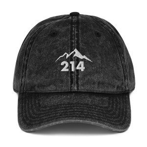 May include: Black vintage washed denim baseball cap with white embroidered mountain range and the number 214.