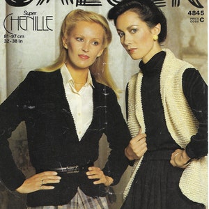 May include: Two women modeling knitwear. The woman on the left is wearing a black blazer with a white shirt and a plaid skirt. The woman on the right is wearing a black turtleneck with a cream-colored knit vest. The text "Super Chenille" and "81-97 cm 32-38 in" is visible in the image.