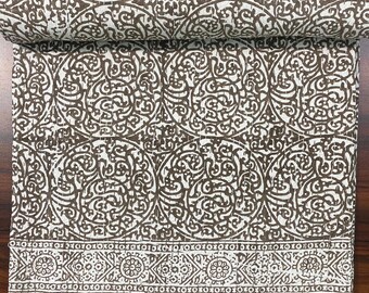 May include: A white cotton kantha quilt with a brown floral pattern. The quilt has a border with a repeating geometric design.