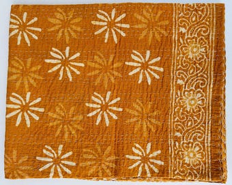 May include: A mustard yellow kantha quilt with a white floral pattern. The quilt has a decorative border with a paisley design.