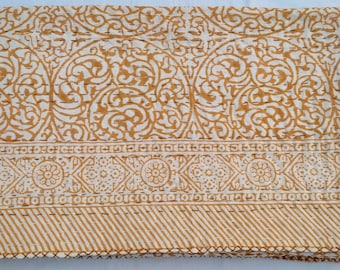 May include: A white cotton kantha quilt with a gold floral pattern. The quilt has a border with a repeating geometric design.