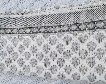 May include: A white cotton quilt with a black and white leaf pattern. The quilt has a border with a geometric design.