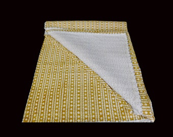 May include: A yellow and white kantha quilt with a striped and dotted pattern. The quilt is folded in half and the white side is visible.