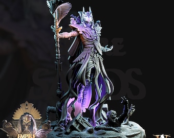 May include: A detailed miniature figurine of a jackal-headed sorcerer, standing on a base with crumbling stone and skeletal figures. The sorcerer wears a black robe and holds a staff topped with an ankh symbol. The figure is painted in shades of gray and purple.