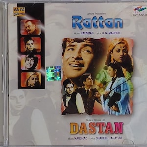 Może przedstawiać: Pudełko CD z tytułami filmów "Rattan" i "Dastan". Okładka zawiera zdjęcia aktorów i aktorek, z informacjami o muzyce i tekstach. Płyta CD znajduje się w przezroczystym plastikowym etui.