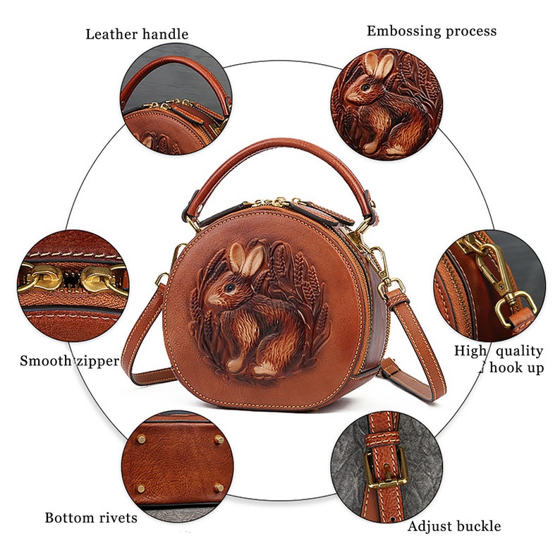 May include: Brown leather round handbag with a detailed embossed rabbit design. Features a top handle, adjustable strap, smooth zipper, and bottom rivets. The bag has a high-quality hook up and an adjust buckle.