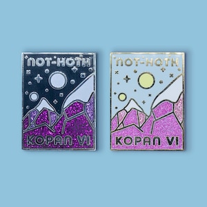May include: Two rectangular enamel pins with mountain and space-themed designs. One pin features a dark night sky with a moon and stars, the other a light blue sky with a sun and stars. Both pins read "NOT-HOTH" and "KOPAN VI".