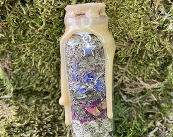 May include: A small glass bottle filled with dried herbs and flowers, sealed with a wax coating and a silver star charm.