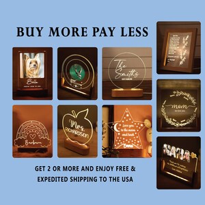 May include: A collection of illuminated personalized gifts, including photo frames, a record-shaped lamp, and a star-shaped night light. The text on the items includes names and phrases like "Bella," "The Smiths," and "Love you to the moon and back."