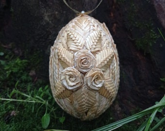 Wooden Easter egg. Decorated with handmade wheat weaving. Christmas decoration. Easter gifts. Environmentally friendly material