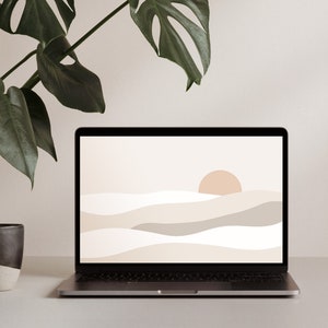 May include: A laptop computer with a minimalist abstract landscape wallpaper on the screen. The wallpaper features a light brown sun and beige and gray waves on a white background. A potted green plant is in the background.