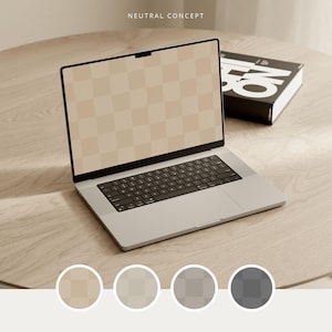 May include: A silver laptop with a black keyboard and a screen displaying a beige checkered pattern sits on a light wood surface. A black book with white text is to the right. The words "NEUTRAL CONCEPT" are at the top.