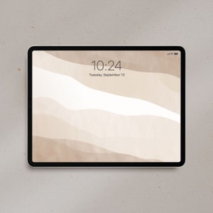 May include: A black tablet displaying a neutral-toned abstract wallpaper with beige and white wavy shapes. The screen shows the time 10:24 and the date Tuesday, September 13. The tablet has a black bezel and a small battery indicator.