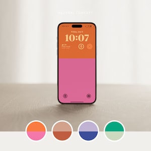 May include: A smartphone mockup with a bright orange and pink colour scheme. The phone screen displays the time "10:07" and the date "Friday, July 5". The phone is sitting on a light brown surface.