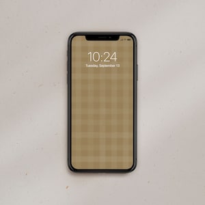 May include: A black smartphone with a brown and white checkered pattern on the screen. The time is 10:24 and the date is Tuesday, September 13.
